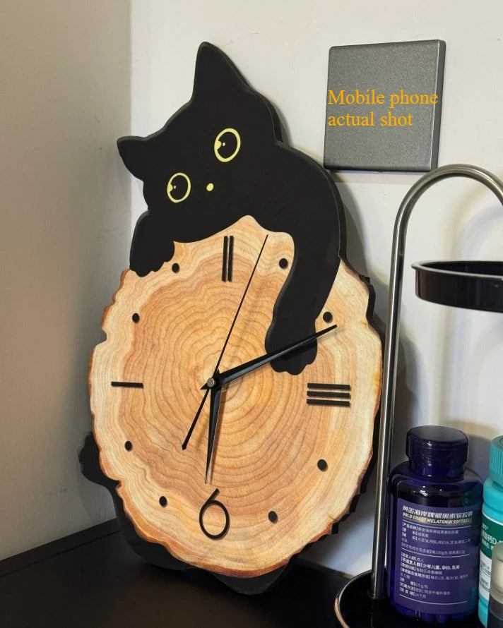 Swinging Cat Wall Clock black cat variant displayed upright on a desktop without the swinging tail