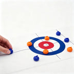 Tabletop Curling Game Set target area with a hand holding a blue roller at the left edge of the mat