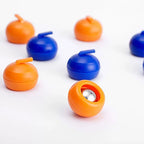 Tabletop Curling Game Set underside view of an orange ball-bearing roller with upright blue and orange pieces