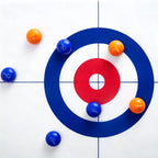 Tabletop Curling Game Set viewed from above with orange and blue rollers around the circular scoring target