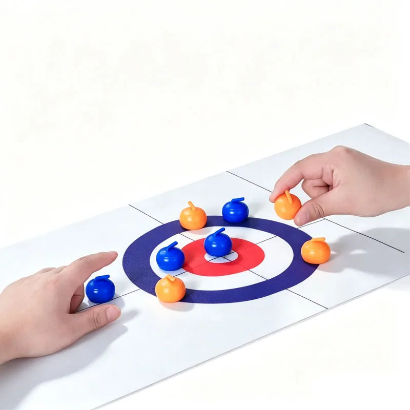 Tabletop Curling Game Set with two hands positioning blue and orange rollers around the red-and-blue target