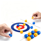 Tabletop Curling Game Set demonstration with two hands and additional blue and yellow rollers beside the mat