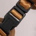 Tactical Dog Backpack Harness close-up showing the black side-release buckle and adjustable brown webbing strap.