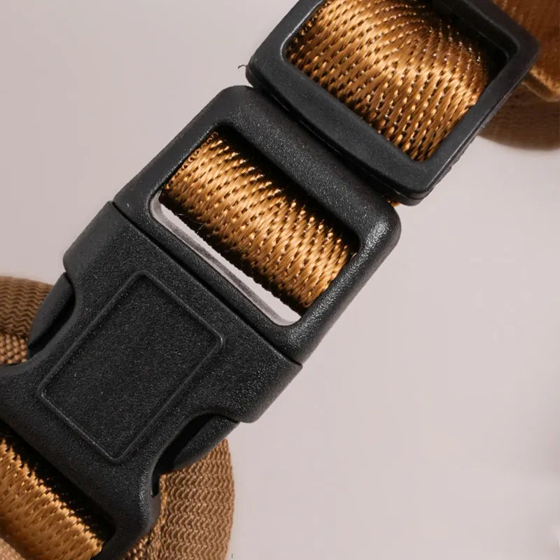 Tactical Dog Backpack Harness close-up showing the black side-release buckle and adjustable brown webbing strap.
