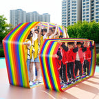 Team Building Race Mat: Adults in yellow vests and children in red jackets using rainbow loops outdoors.