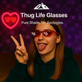 HighPeak Thug Life Glasses in red pixelated design worn by smiling woman flashing peace sign indoors