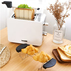 Toaster Sandwich Rack holding a sandwich in a white toaster beside bread and a separate croissant rack.