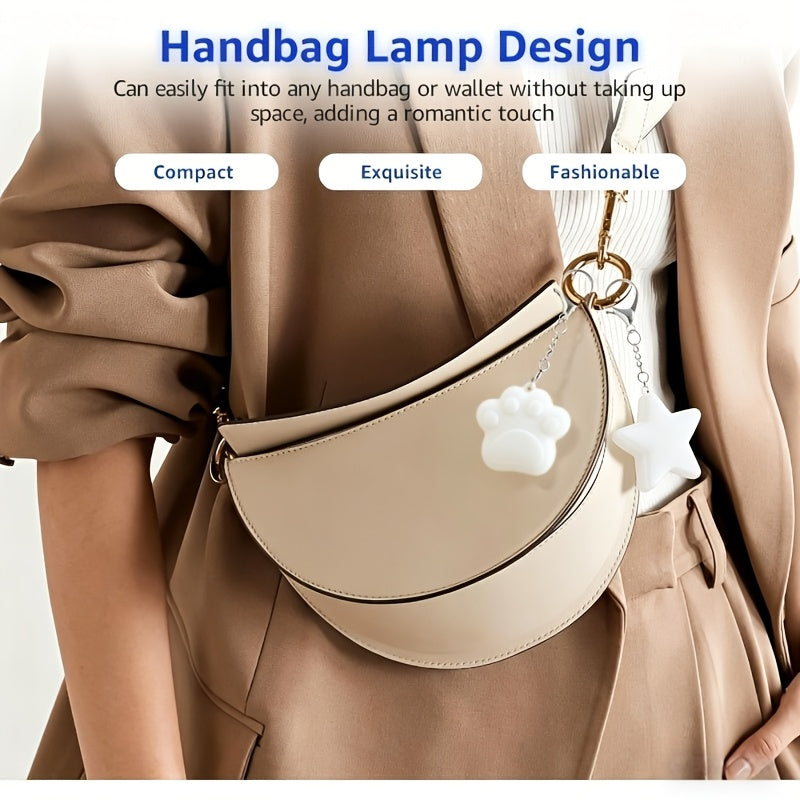 Touch Activated Bag Light — Paw and Star shapes shown as charms on a cream shoulder bag.