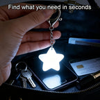 Touch Activated Bag Light — Star shape held over keys and a phone inside a dark purse.