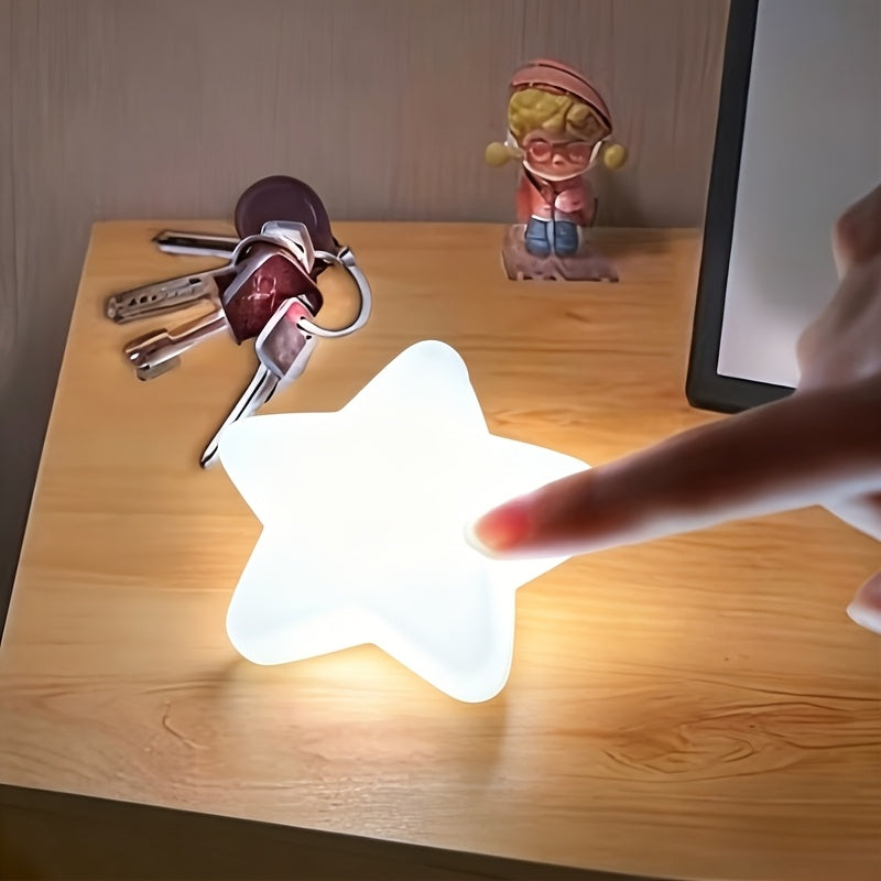Touch Activated Bag Light — Star shape being touched on a wooden surface beside keys.