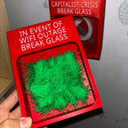 Touch Grass Meme Box held in one hand with its Wi-Fi outage message and green grass visible