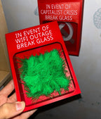Touch Grass Meme Box handheld view with another novelty emergency box in the background