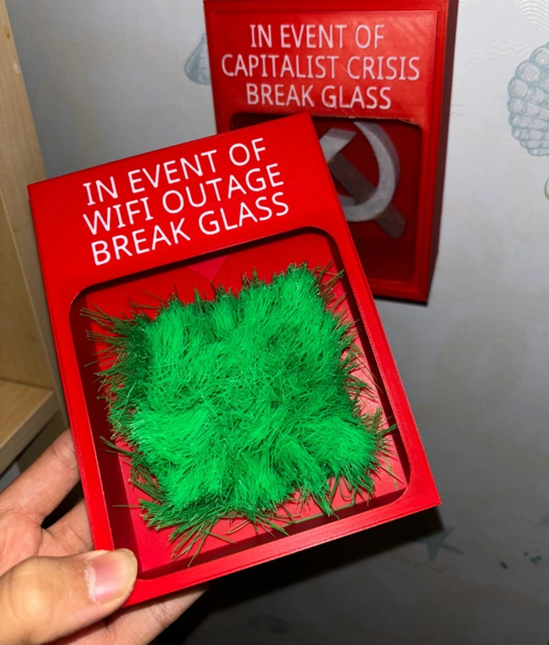 Touch Grass Meme Box handheld view with another novelty emergency box in the background