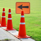 Traffic Cone Arrow Sign mounted outdoors with multiple cones marking a directional route beside grass