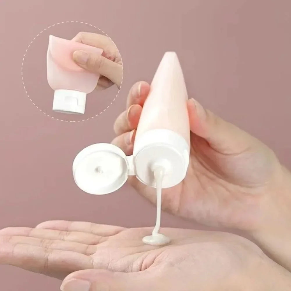 Travel Squeeze Bottle Set pink bottle dispensing lotion into a hand, with an inset showing the flexible body squeezed.