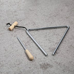 Triangle Instrument Set angled on a textured gray surface, showing its open corner, cord and beater