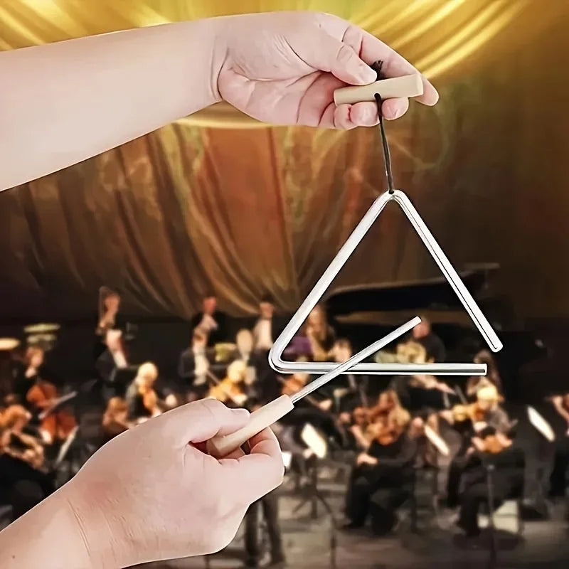 Triangle Instrument Set held by its handle with the beater poised in front of an orchestra backdrop