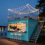 Two-Story Container Restaurant in blue with rooftop string lights, stairs, and a lakeside café window