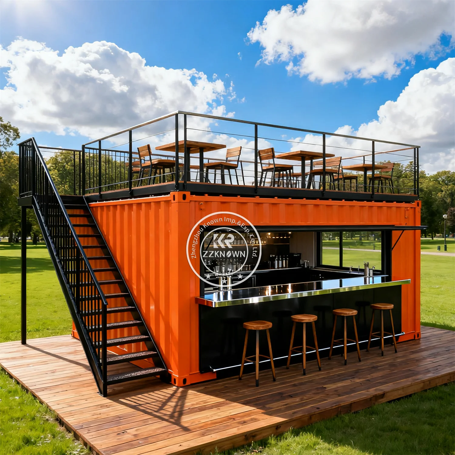 Two-Story Container Restaurant in orange with a black serving counter and rooftop tables in a park