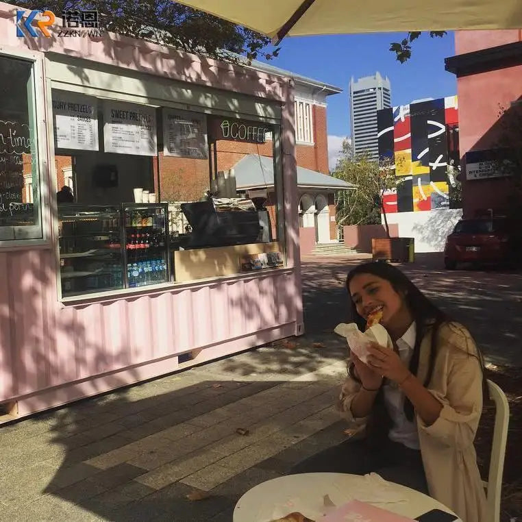 Pink container café example with a customer dining beside the service window in an urban courtyard
