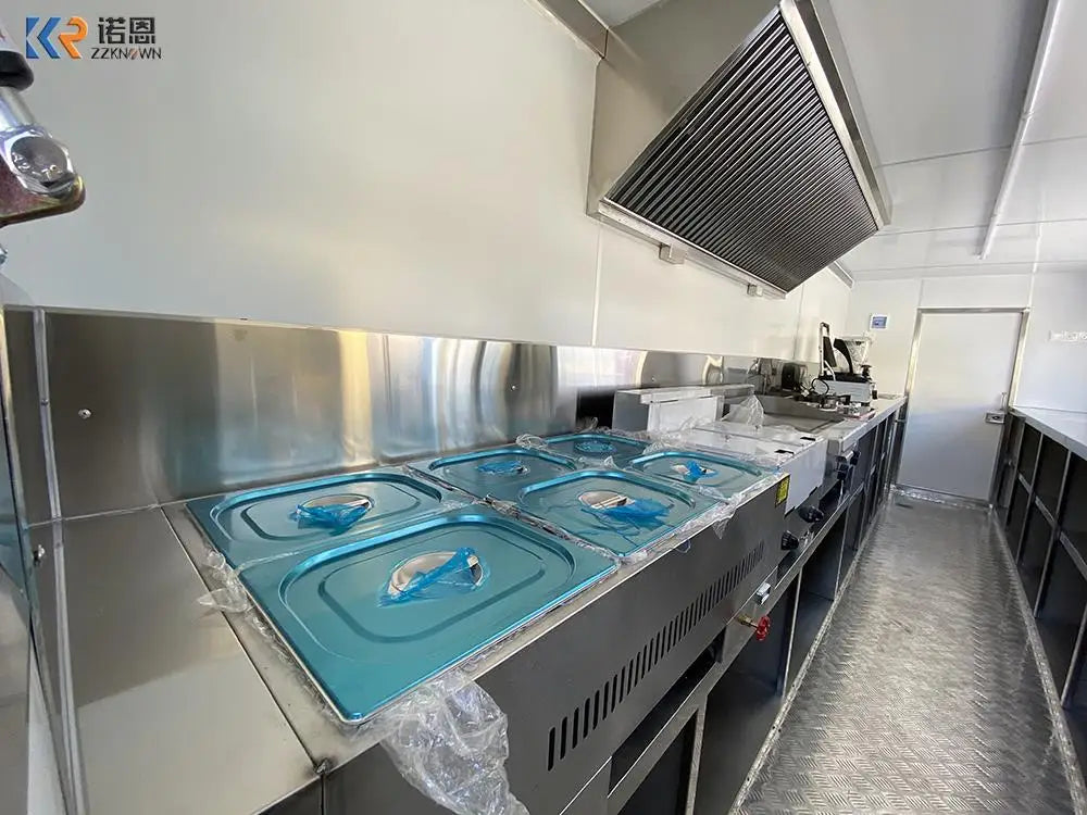 Example container restaurant prep interior with stainless work surfaces, food pans, ventilation, and storage