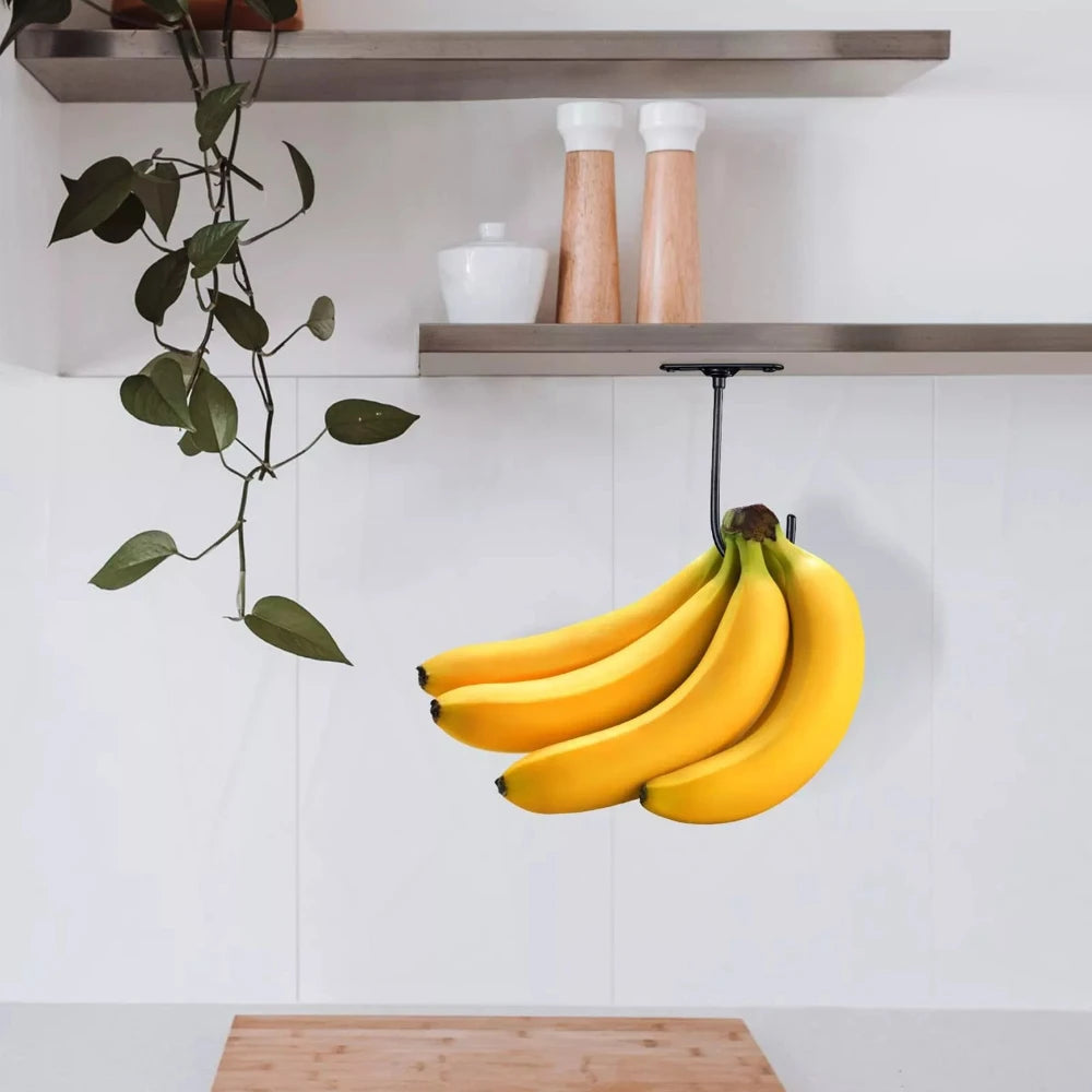 Under-Cabinet Banana Hook holding a banana bunch beneath a wood shelf in a minimalist kitchen