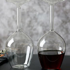 Empty and filled Upside Down Wine Glasses showing the clear bowl and hollow stem