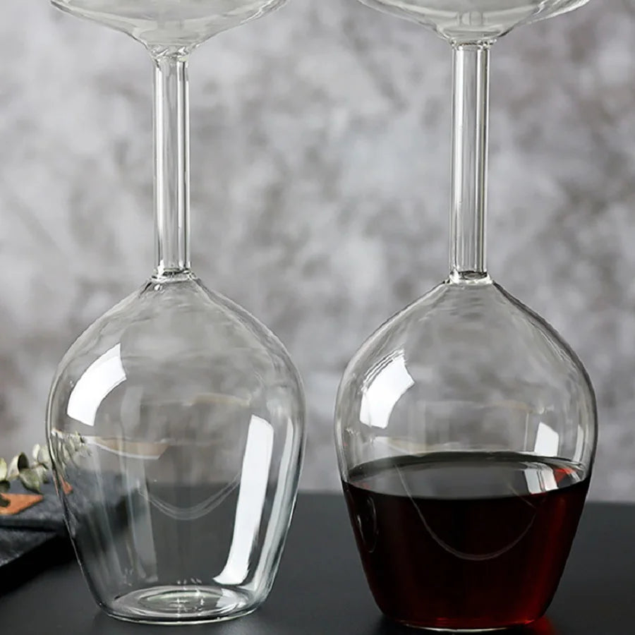 Empty and filled Upside Down Wine Glasses showing the clear bowl and hollow stem