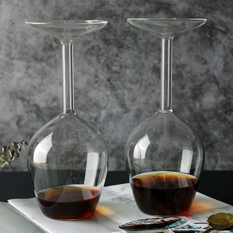 Two clear Upside Down Wine Glasses with dark drinks displayed side by side