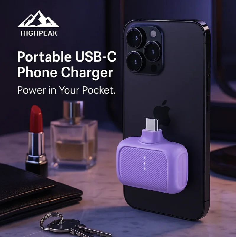 HighPeak Portable USB-C Phone Charger in purple attached to black phone with a keychain and daily essentials nearby