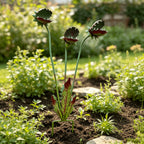 Venus Flytrap Garden Stake full view with three stems, decorative leaves and ground prongs in a flower bed