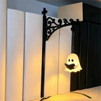 Vintage Bookshelf Lantern reading ghost glowing between white and black books on a shelf