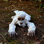 Voice-Activated Crawling Mummy crawling over a forest floor with both arms extended