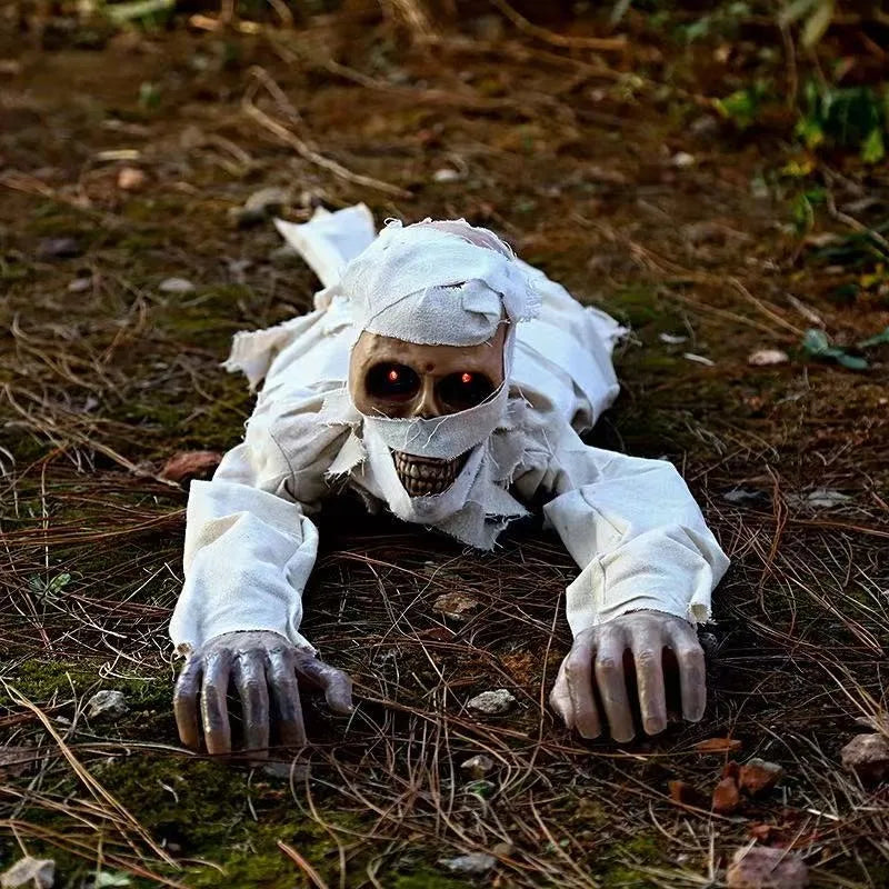 Voice-Activated Crawling Mummy crawling over a forest floor with both arms extended