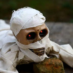 Voice-Activated Crawling Mummy close-up showing its wrapped skull face, teeth, and red LED eyes