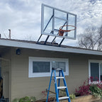 Wall-Mounted Basketball Hoop installed on an outdoor backboard above a residential garage