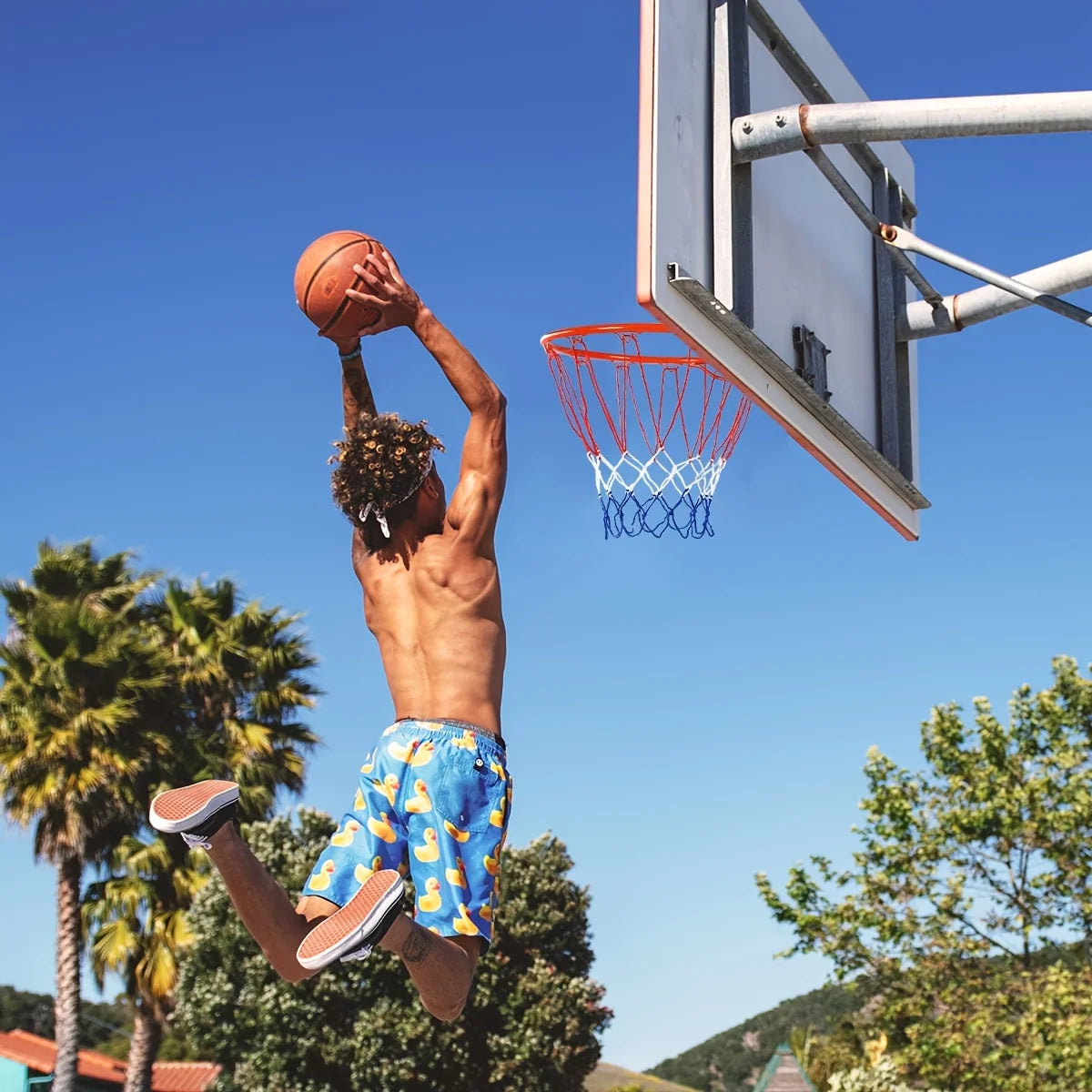 Wall-Mounted Basketball Hoop shown on an outdoor backboard while a player jumps for a dunk