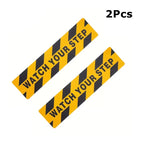 Watch Your Step Decals supplier example showing two black-and-yellow strips on a white background