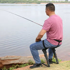 Wearable Exoskeleton Chair supporting a seated angler while fishing beside a lake