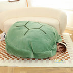 Wearable Turtle Shell Pillow in green used as a large cozy floor and sofa lounger