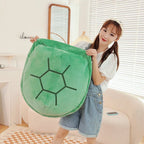 Wearable Turtle Shell Pillow in green held upright by a person for an easy size reference