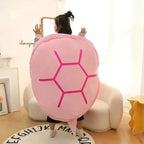 Wearable Turtle Shell Pillow in pink worn on the back to show its playful shell silhouette