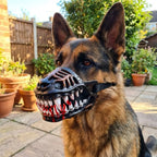 German Shepherd showing Werewolf Fangs Dog Mask with blood-effect teeth beside garden pots in daylight