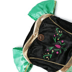 Winter Fairytale Princess Dress close-up of the green dress bodice with floral decoration and gold-colored neckline trim