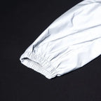 Women’s Reflective Joggers close-up of an elastic ankle cuff reflecting direct light on a dark background