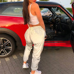 Women’s Reflective Joggers rear view beside a red car, showing the gathered waist and cuffed hems