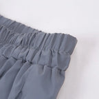 Women’s Reflective Joggers close-up of the gray gathered waistband and parallel rows of stitching