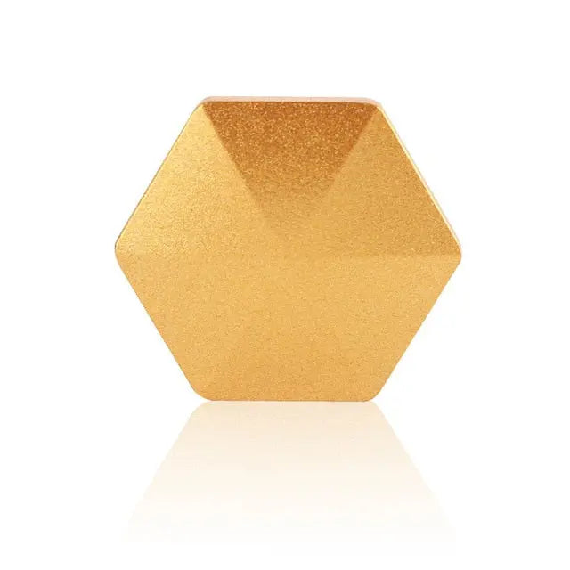 HexFlip metallic gold hexagonal fidget toy on white background with reflection - stress relief desk accessory