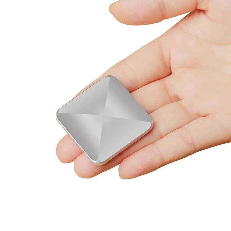 HexFlip fidget toy in metallic silver with geometric design shown in hand - compact stress relief gadget