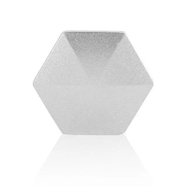 HexFlip metal fidget toy in silver hexagonal shape on white background with reflective surface